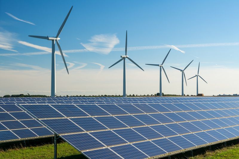 Wind turbines and solar panels on a renewable energy farm